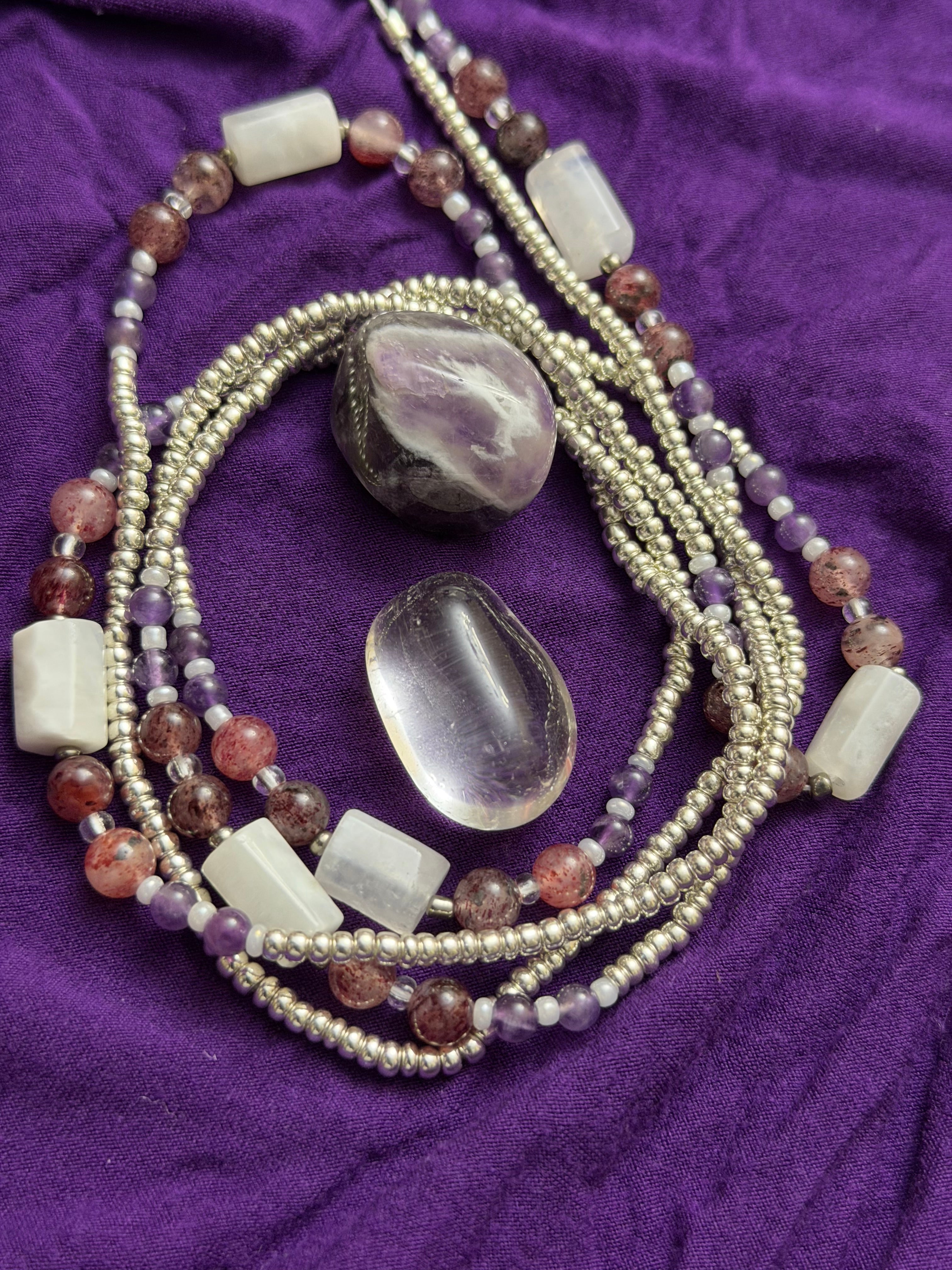 Beaded necklace with stones on a purple fabric background